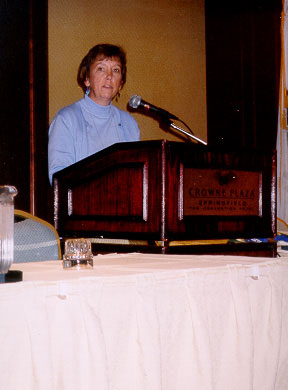 Micki Ostrosky announces the 2003 Jeanette McCollum Service to the Field awardee.